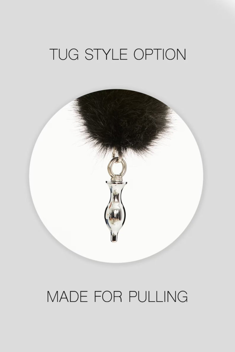 a black furry ball hanging from a metal hook